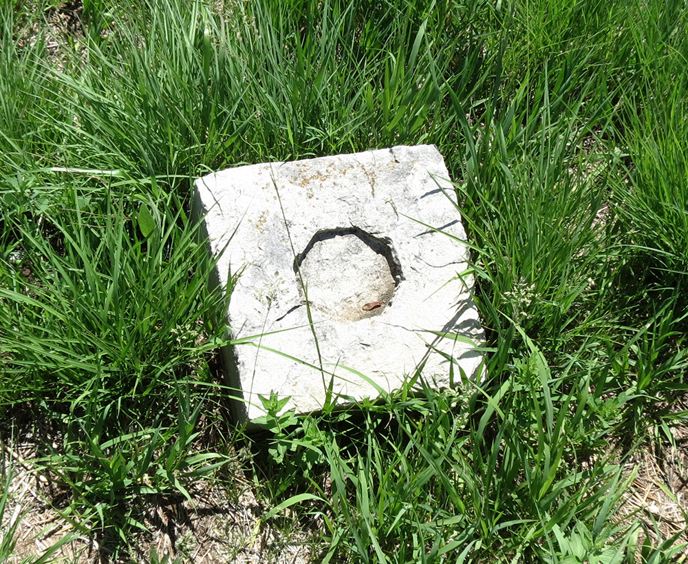 One of the other stones in the cemetery with an octagonal indentation